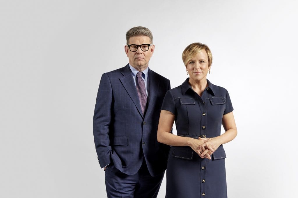 John Campbell and Hilary Barry stand in a room, looking at the camera