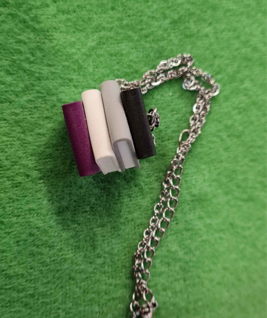 a necklace with a books keychain